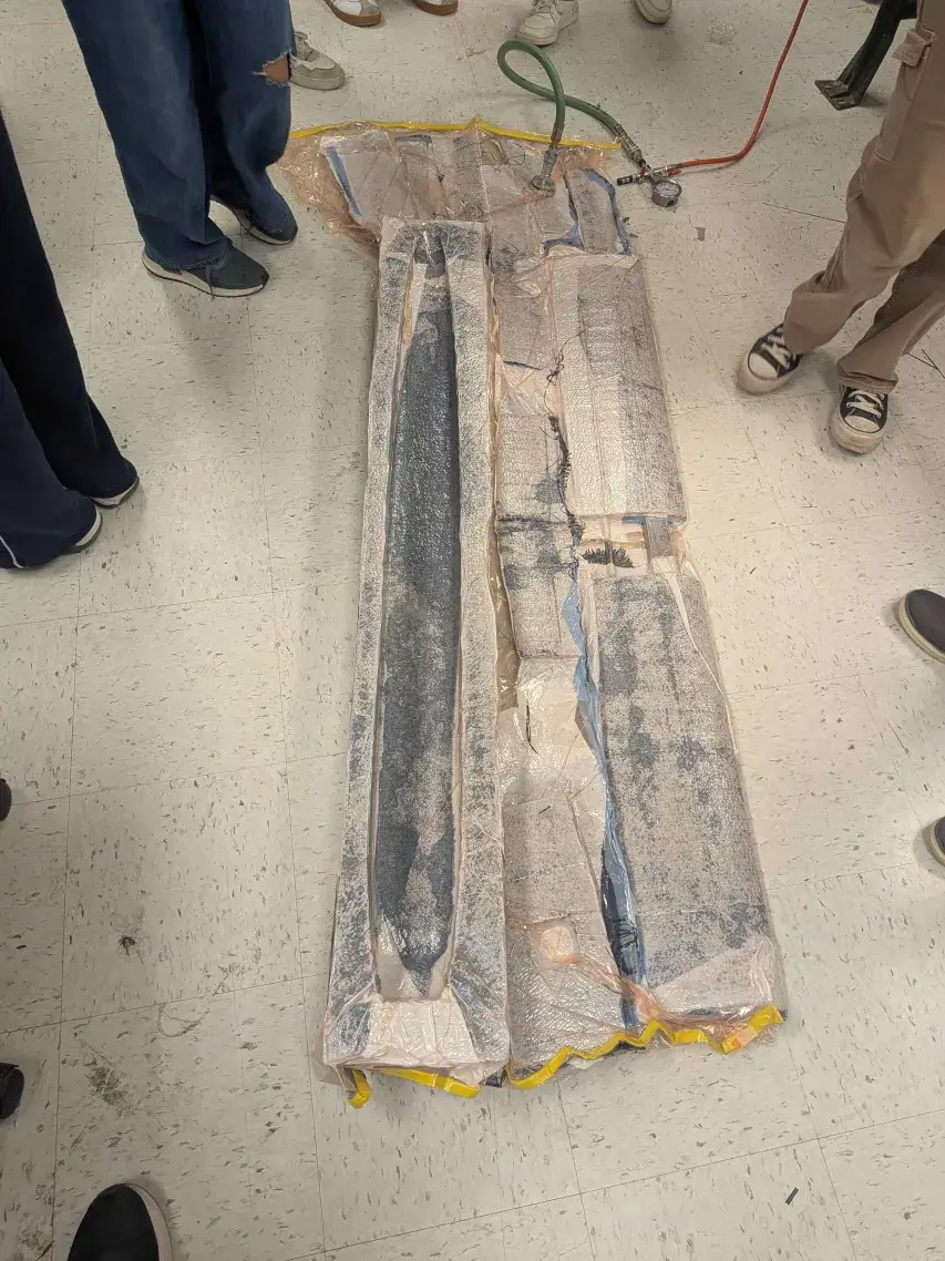 Carbon fiber parts curing under a vacuum bag